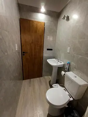 a bathroom with a toilet and a sink at Piedras Blancas in La Bajada