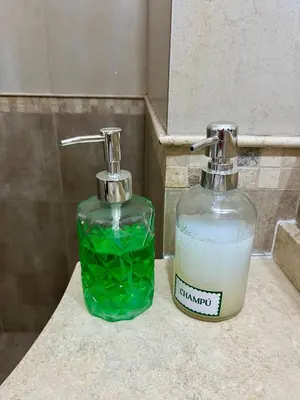 two bottles of soap sitting on a bathroom sink at Dulce de Córdoba in Cordoba