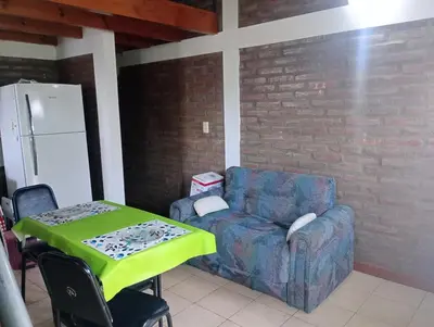 a living room with a couch and a green table at El Cardal II in Río Cuarto