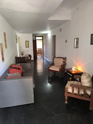 a living room with two couches and a table at Casa Milu in Mina Clavero