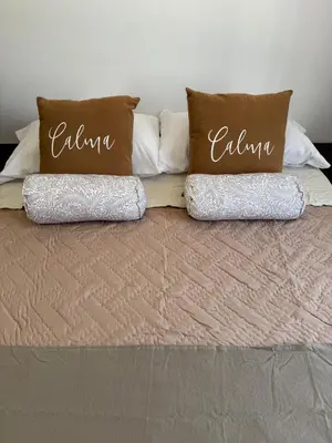 a bed with two pillows on top of it at Puntasol vcpaz in Villa Carlos Paz