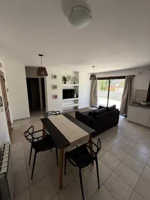 a living room with a table and a couch at Puntasol vcpaz in Villa Carlos Paz
