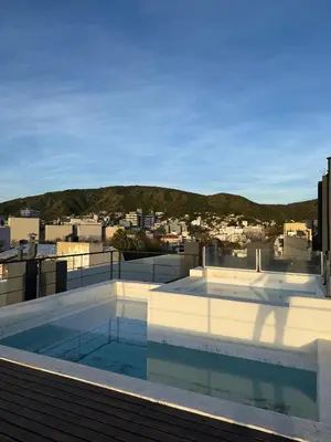 a swimming pool on the roof of a building at Puntasol vcpaz in Villa Carlos Paz