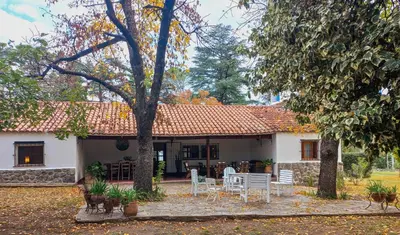 a house with a table and chairs in front of it at Casa Paine in San Javier