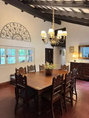 a dining room with a wooden table and chairs at Casa Paine in San Javier
