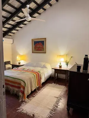 a bedroom with a bed and two tables with lamps at Casa Paine in San Javier