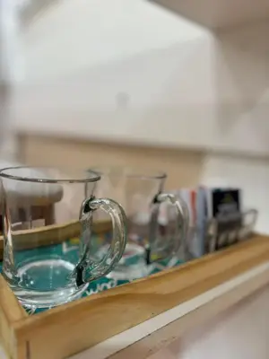 two glass mugs sitting on a wooden shelf at Acogedor Depto Boutique - Centro Histórico Córdoba in Cordoba