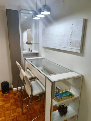 a room with a glass counter with two chairs at Acogedor Depto Boutique - Centro Histórico Córdoba in Cordoba
