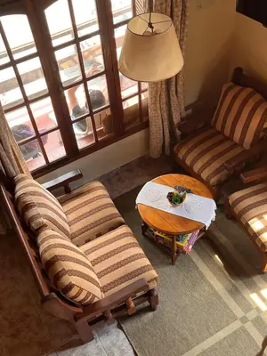 a living room with a couch and a chair and a table at Un escape mágico en el centro de la ciudad in Villa General Belgrano