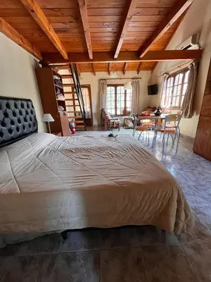 a large bedroom with a large bed in a room at Un escape mágico en el centro de la ciudad in Villa General Belgrano