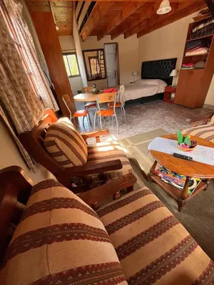a living room with a couch and a table at Un escape mágico en el centro de la ciudad in Villa General Belgrano