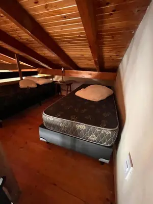 a room with two beds in a attic at Un escape mágico en el centro de la ciudad in Villa General Belgrano