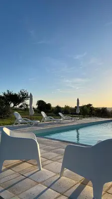 a swimming pool with lounge chairs and a swimming pool at Complejo los Torres in Mina Clavero