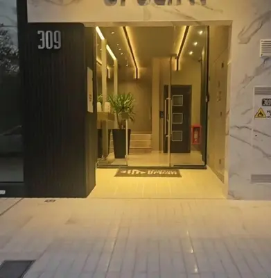 an empty hallway of a building with a glass door at Centrico con Garage Monoambiente a Estrenar in Villa Dolores