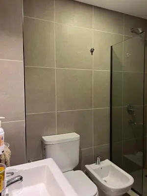 a bathroom with a toilet and a sink and a shower at Centrico con Garage Monoambiente a Estrenar in Villa Dolores