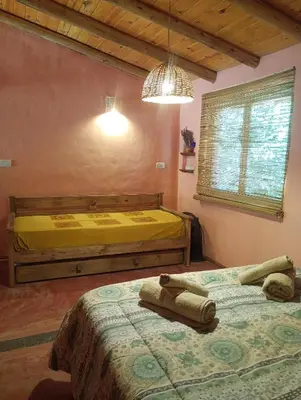 a bedroom with two beds with towels on them at La Margarita in Villa Ciudad Parque