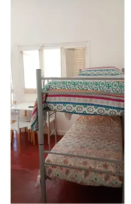 two bunk beds in a room with a table at El Dpto de Gabicito IV in Cordoba