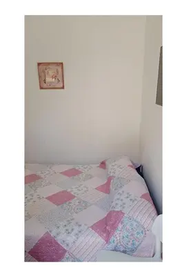 a bed in a room with a quilt on it at El Dpto de Gabicito IV in Cordoba