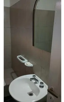 a bathroom with a white sink and a mirror at El Dpto de Gabicito IV in Cordoba