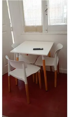 a white table and chairs with a remote on it at El Dpto de Gabicito IV in Cordoba