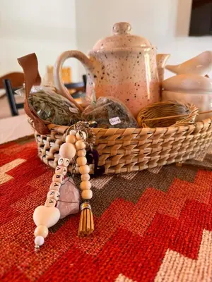 a basket of food and a rosary on a table at Entre Algarrobos - Cabañas con pileta y naturaleza in Villa de Las Rosas