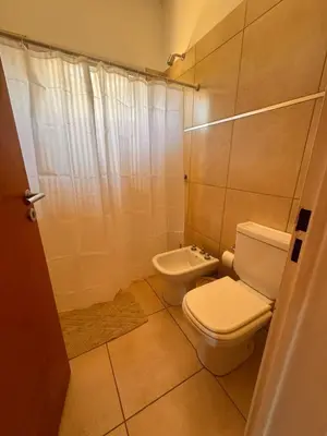 a bathroom with a toilet and a sink at Entre Algarrobos - Cabañas con pileta y naturaleza in Villa de Las Rosas