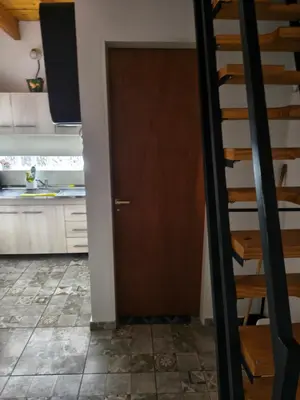 a kitchen with a staircase and a door in a room at Los Bichos in Estancia Vieja