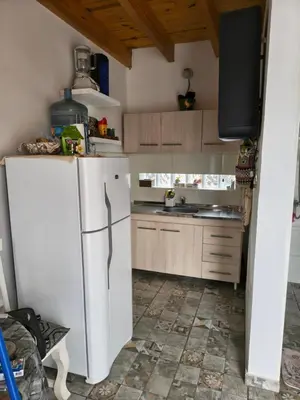 a kitchen with a white refrigerator and a sink at Los Bichos in Estancia Vieja