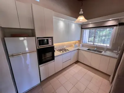 a kitchen with white cabinets and a white refrigerator at Casa de Campo a metros del rio en las Sierras de Cordoba in Atos Pampa