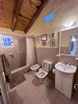 a bathroom with a sink and a toilet and a tub and a sink at Casa de Campo a metros del rio en las Sierras de Cordoba in Atos Pampa