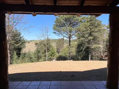 a view of a field from the inside of a building at Casa de Campo a metros del rio en las Sierras de Cordoba in Atos Pampa