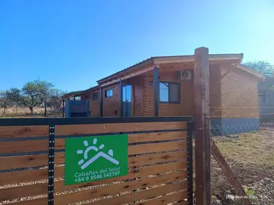 a house with a fence in front of it at Cabanas del Solar in Los Reartes