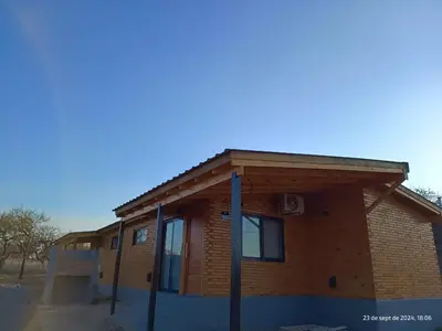 a building with awning on the side of it at Cabanas del Solar in Los Reartes