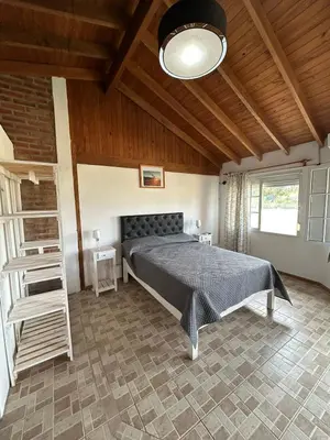 a bedroom with a bed and a wooden ceiling at Agosto 23 in Mina Clavero