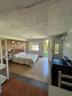 a bedroom with a bed and a couch in a room at Agosto 23 in Mina Clavero