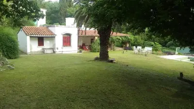 a white house with a tree in the yard at La Victoria descanso Cordobes in Cordoba