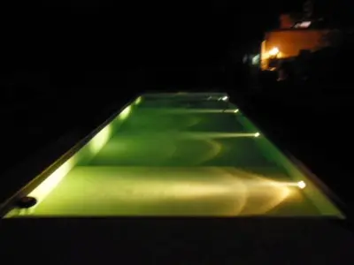 a green object with lights on it in the dark at La Victoria descanso Cordobes in Cordoba