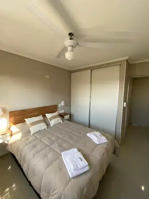 a bedroom with a large bed with two towels on it at Departamento en córdoba, complejo Altos de Villasol , 3 dormitorios, 2 baños in Cordoba