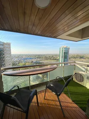 a balcony with two chairs and a table and a view at Departamento en córdoba, complejo Altos de Villasol , 3 dormitorios, 2 baños in Cordoba