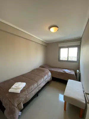 a room with two beds and a table in it at Departamento en córdoba, complejo Altos de Villasol , 3 dormitorios, 2 baños in Cordoba