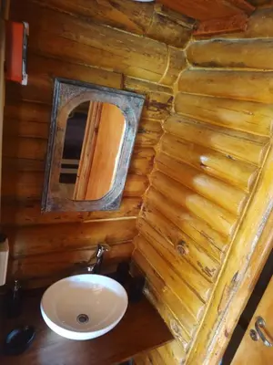 a small bathroom with a sink and a mirror at Refugio Doña Josefa, cabaña de montaña La Cumbrecita in La Cumbrecita