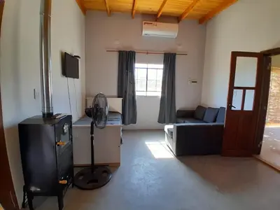 a room with a living room with a couch and a room with at Sonidos del Silencio in Las Rabonas
