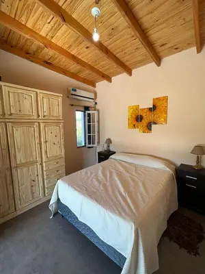a bedroom with a bed and a wooden ceiling at Sonidos del Silencio in Las Rabonas