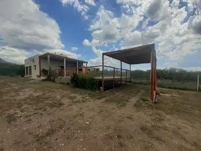 a building with a shed in the middle of a field at Sonidos del Silencio in Las Rabonas