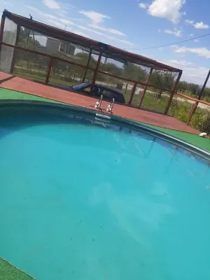 a large swimming pool with a wooden deck at Sonidos del Silencio in Las Rabonas