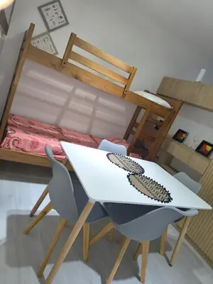 a table and chairs in a room with a bed at Departamento Loft Cima del Cielo - Miralejos 16 Premium Resort in Villa Carlos Paz