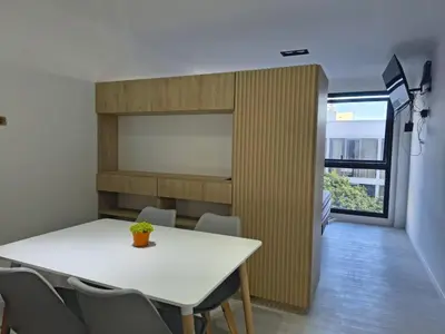 a dining room with a white table and chairs at Departamento Loft Cima del Cielo - Miralejos 16 Premium Resort in Villa Carlos Paz
