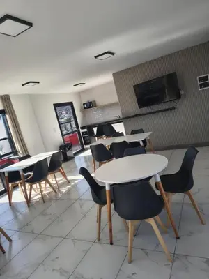 a group of tables and chairs in a room at Departamento Loft Cima del Cielo - Miralejos 16 Premium Resort in Villa Carlos Paz