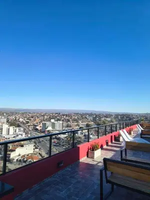 a balcony with benches and a view of a city at Departamento Loft Cima del Cielo - Miralejos 16 Premium Resort in Villa Carlos Paz