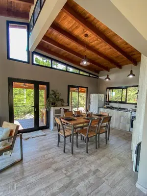 a kitchen and dining room with a wooden table and chairs at Finca del Campito in Villa Berna